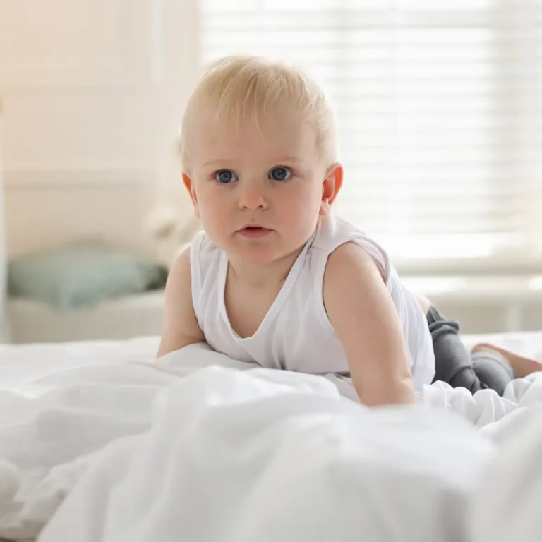 Bedtime. Cute little baby on bed at home