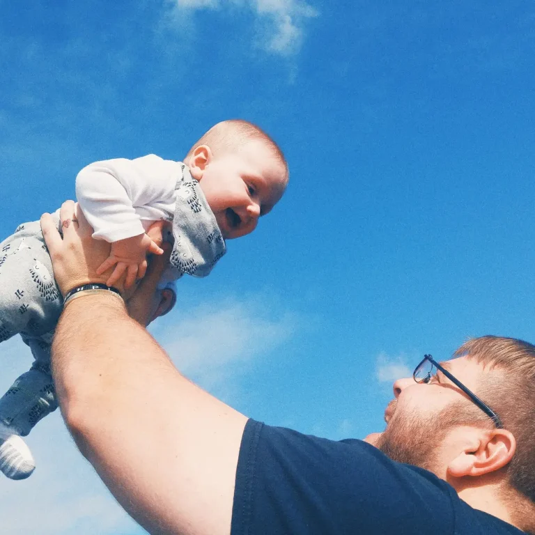 happy-with-playing-with-son-against-sky