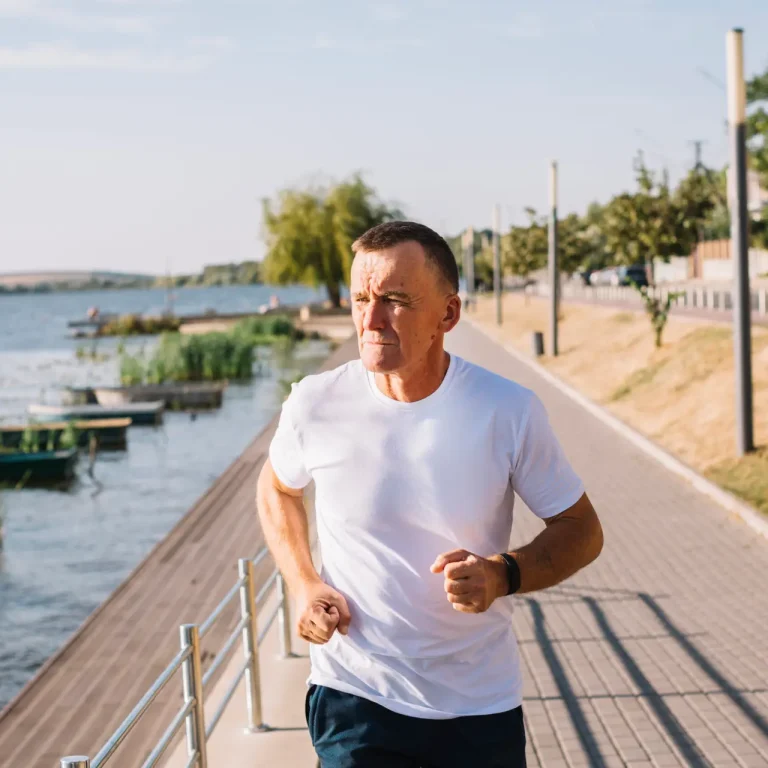 man-running-by-lake-medium-shot