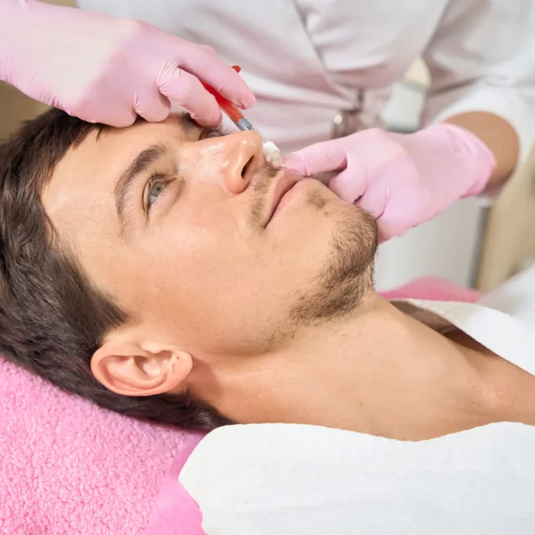 Young man receiving aesthetic skin treatment at a clinic